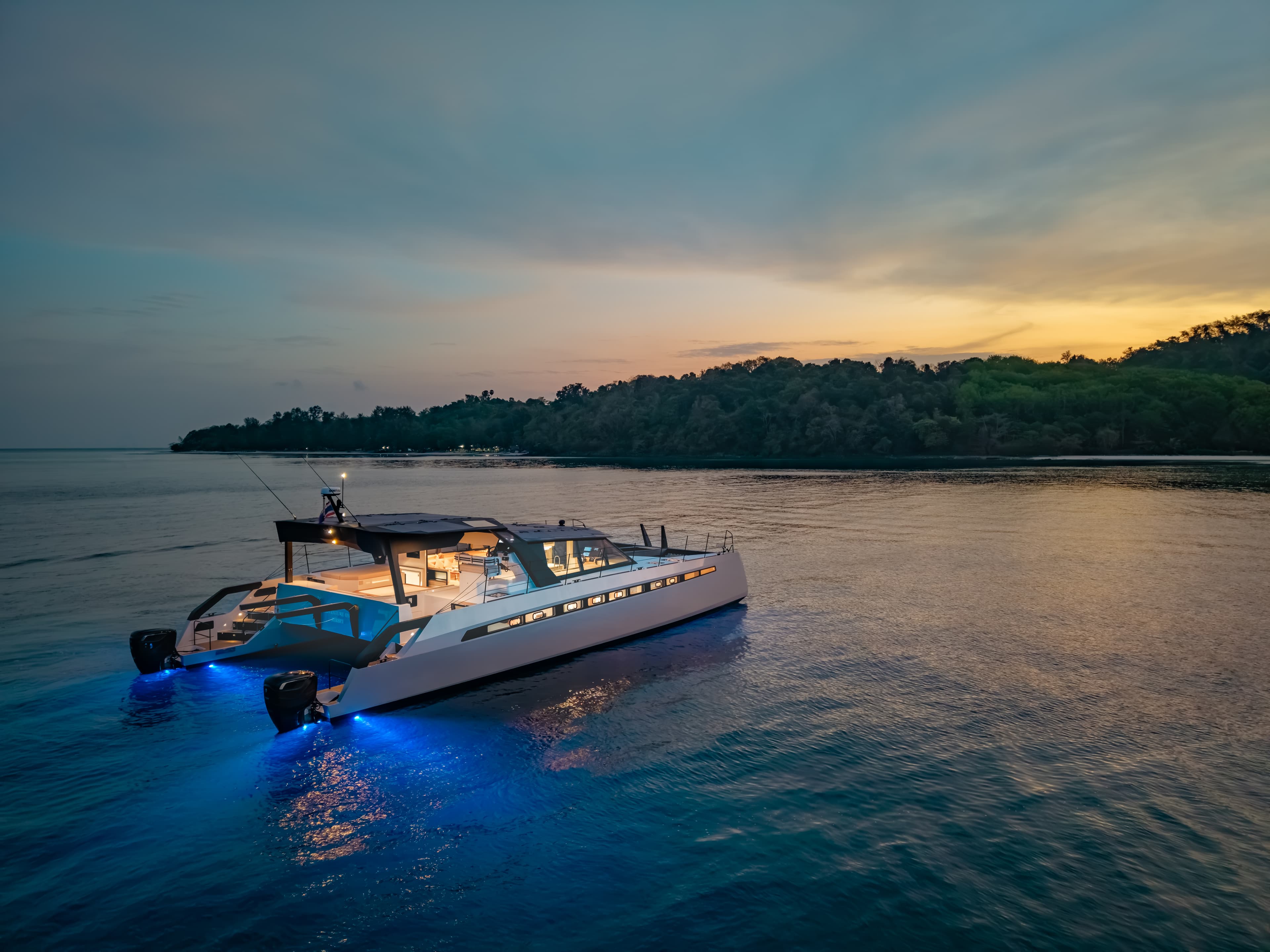 Adventure One — AY60 Sport hull #1 with underwater LED lighting at twilight